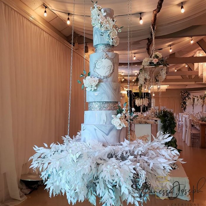 rustic chic wedding cake marbled gray white silver on hanging table with white and silver leaves 