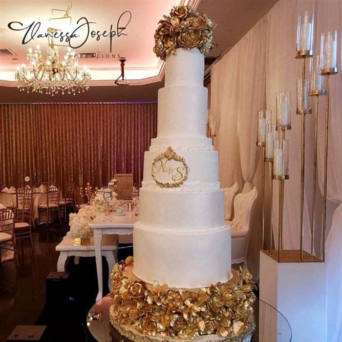 white wedding cake with golden flowers tiers