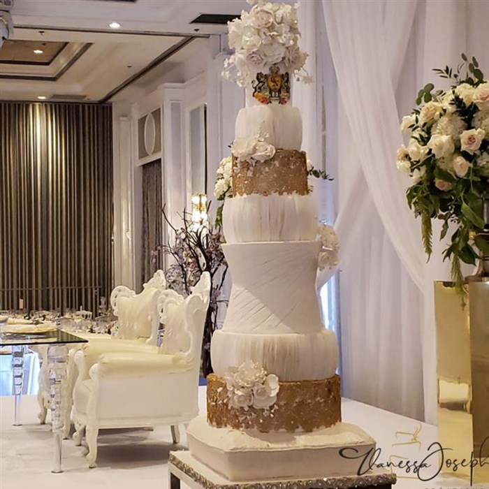  textured white wedding cake with gold lace