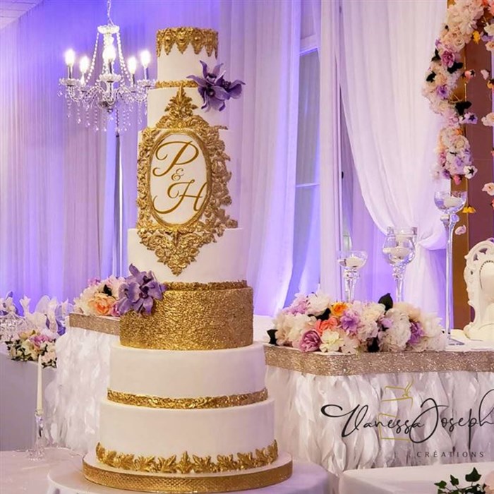 Royal white and gold wedding cake with purple lilas flowers
