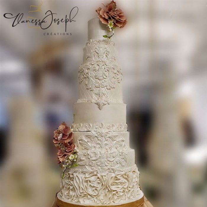 Baroque white wedding cake with pink flowers