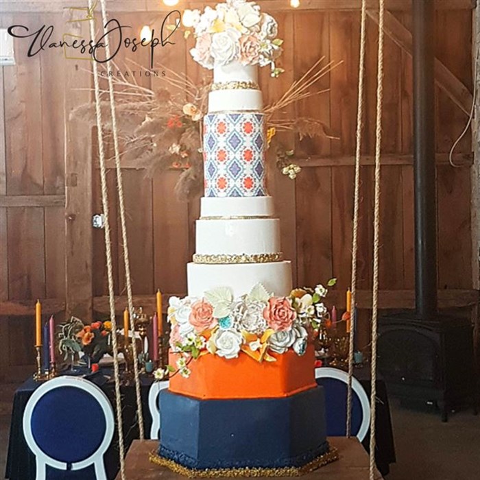 Spanish style orange white navy blue and gold wedding cake