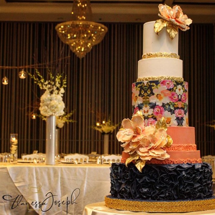 Modern white, salmon, navy blue wedding cake with flower pattern