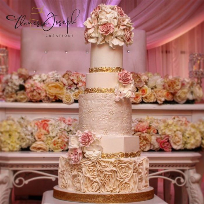 romantic white and gold wedding cake with pink flowers