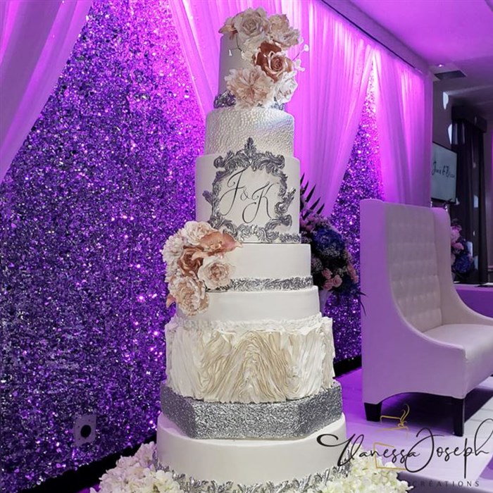 White and silver wedding cake with pink flowers