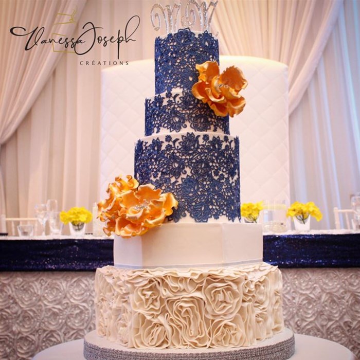 white wedding cake with blue lace marine and yellow flowers