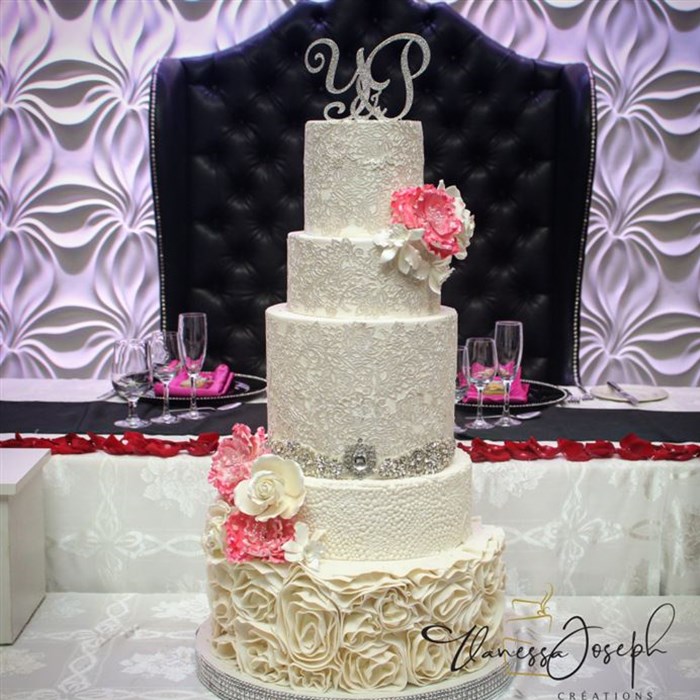 white wedding cake with lace and fuchsia flowers