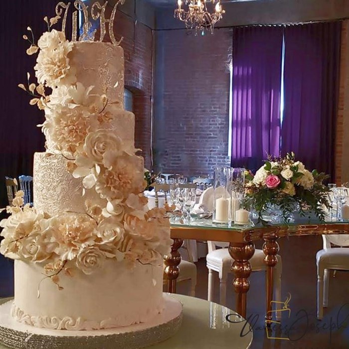 White wedding cake with cascade pink blush flowers